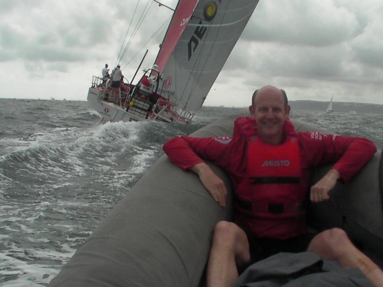 Rupert Pearce in an inflatable behind Team Dongfeng's vessel 