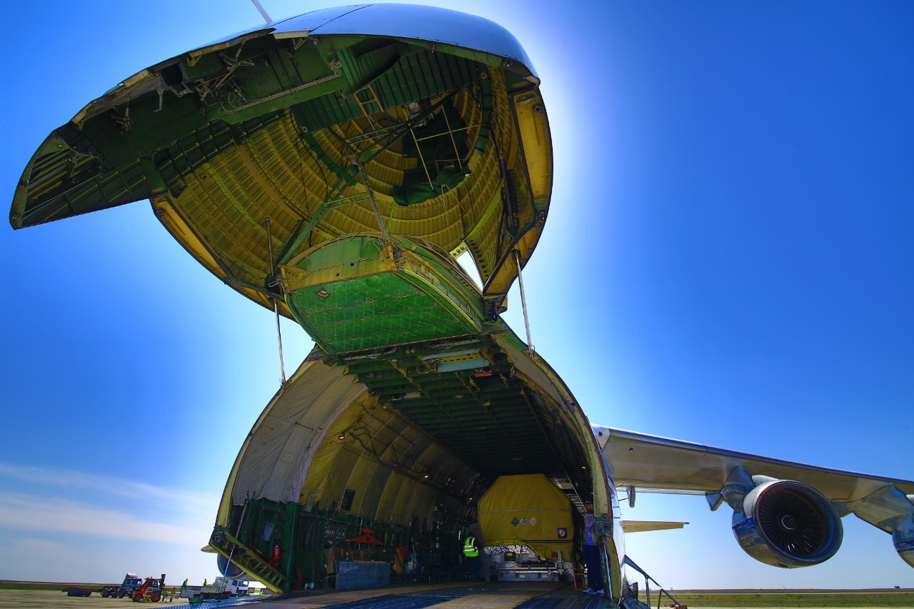 Looking inside the An-124 aircraft at the protective casing holding the GX3 spacecraft awaiting unloading