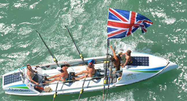Team Essence in their boat flying the Union Flag