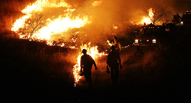 First responders approaching a fire in the countryside