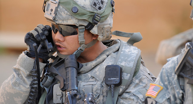 Military personnel using a radio