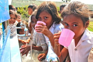 Children drinking fresh clean water enabled by Planet Water Foundation 