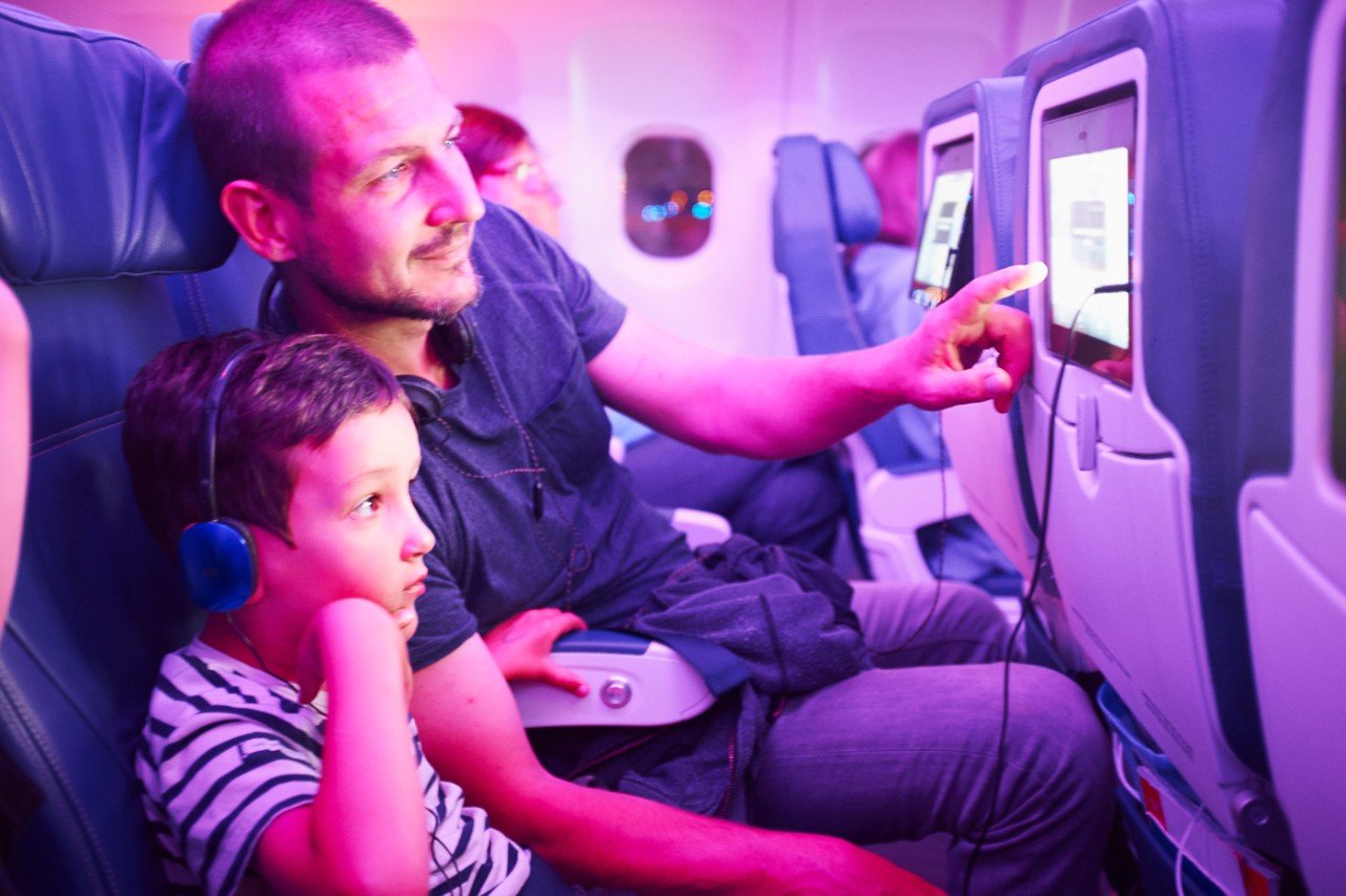 Father and son watching content on an aircraft