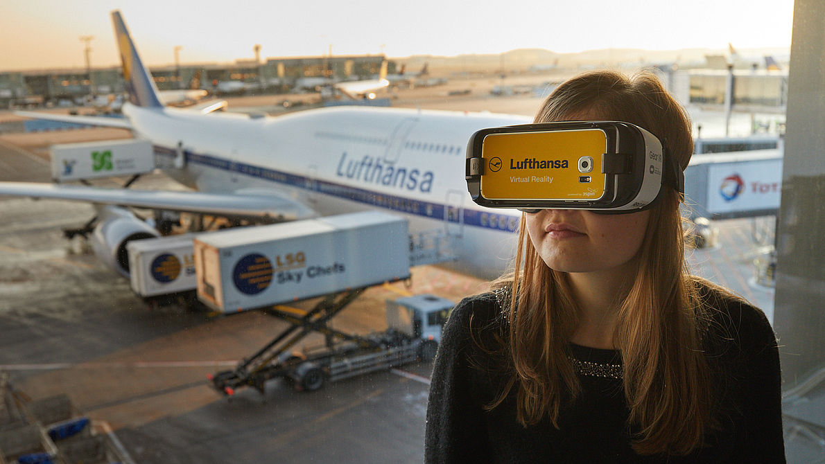 Woman wearing a Lufthansa-branded VR device