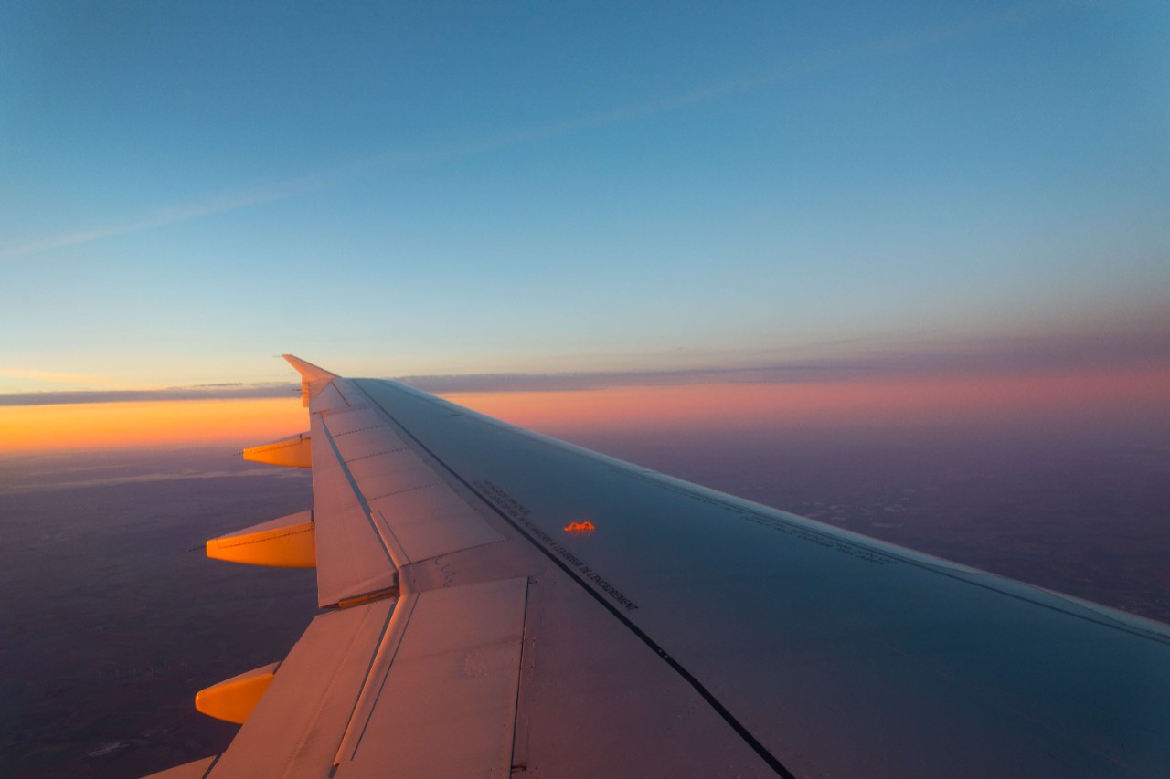Airplane window shot during dawning sky