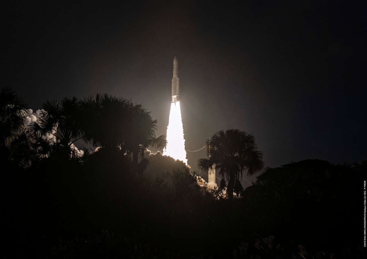 An Ariane 5 rocket carrying GX5 rises above the trees during its night time launch