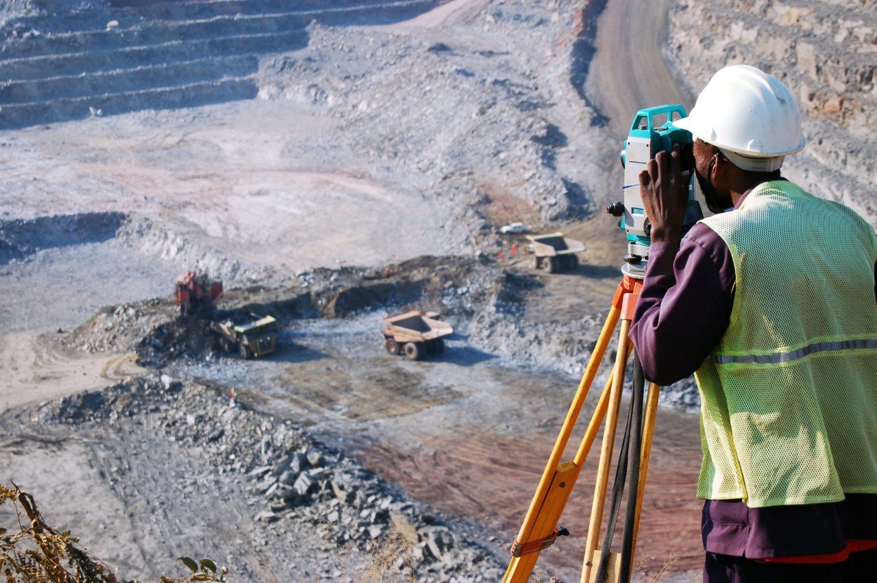 Engineer using equipment to surveying the pit