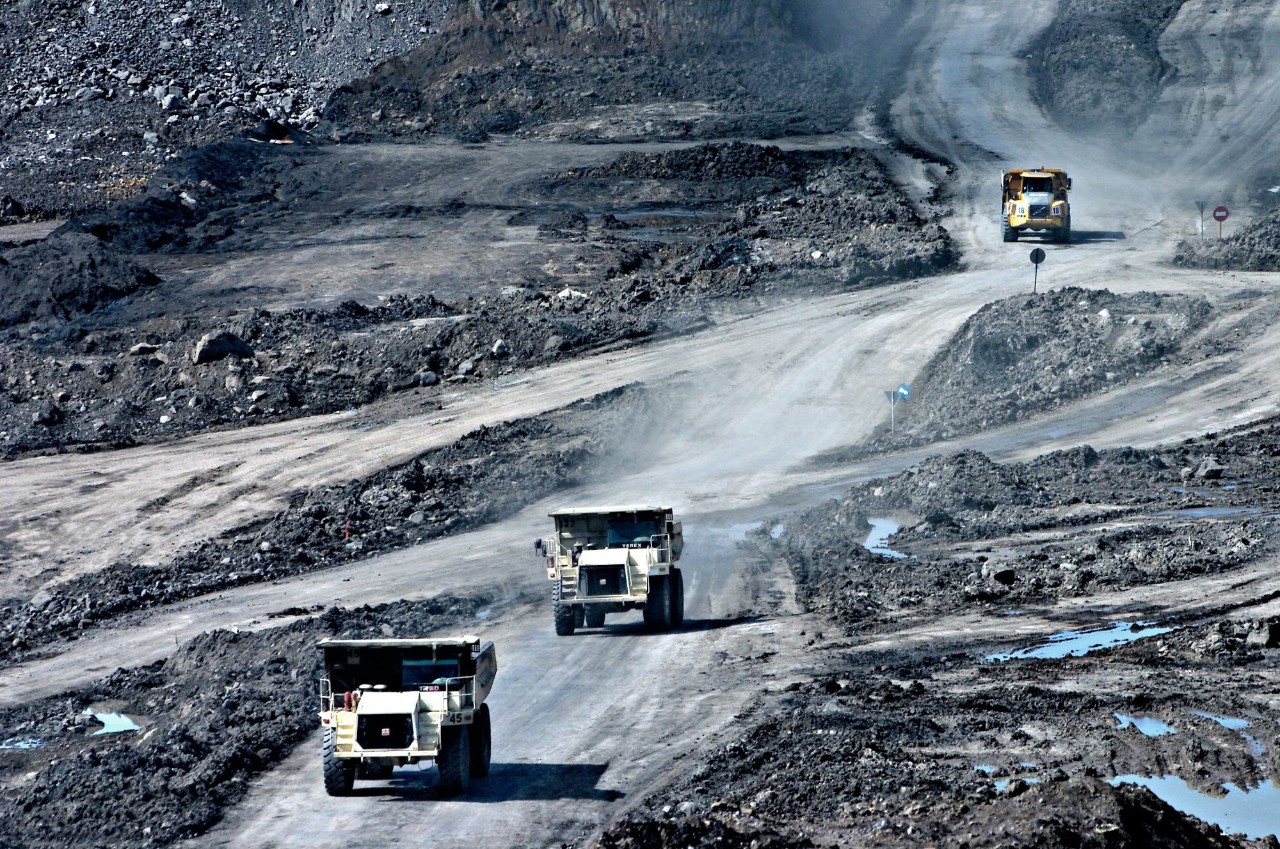 Mine dump trucks driving through an opencast mine