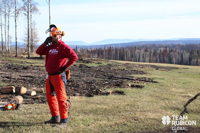 Team Rubicon Canada volunteer using a satellite phone