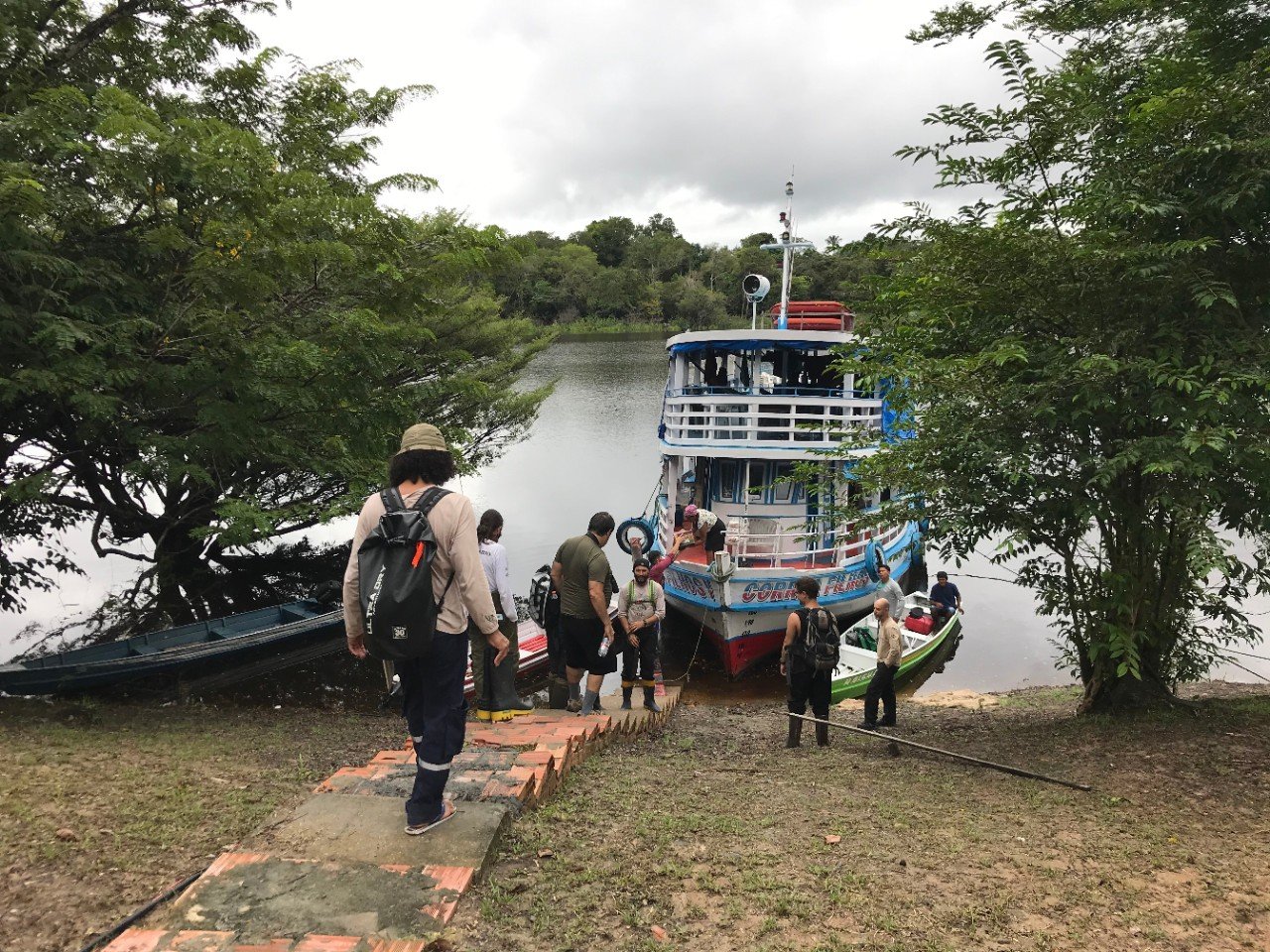 Members of the local Cooperative CoopXixuau board a boat on the Rio Branco Jauaperi, their only means of transport through the Amazon rainforest to transport food and other supplies.