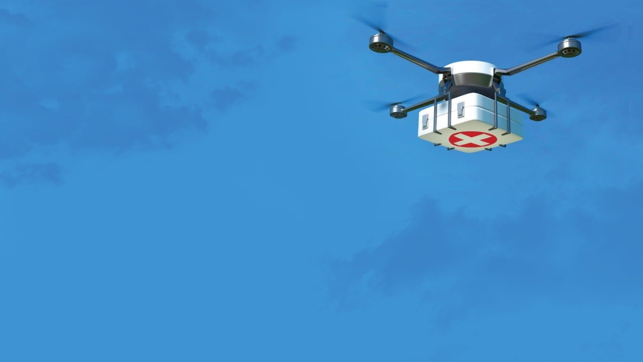 Drone in the blue sky with a medical red cross