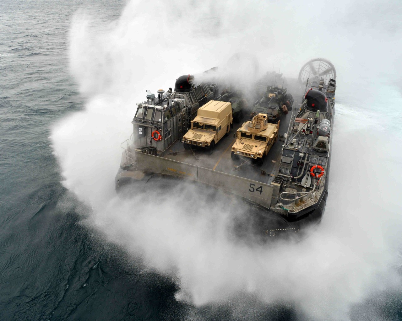 A U.S. Navy Landing Craft Air Cushion, more commonly known as an LCAC, approaches the well deck of the amphibious assault ship USS Bataan (LHD 5) in the Atlantic Ocean on Oct. 31, 2013.  The Bataan and the 22nd Marine Expeditionary Unit are underway conducting routine qualifications.  DoD photo by Petty Officer 3rd Class Erik Foster, U.S. Navy.  (Released)