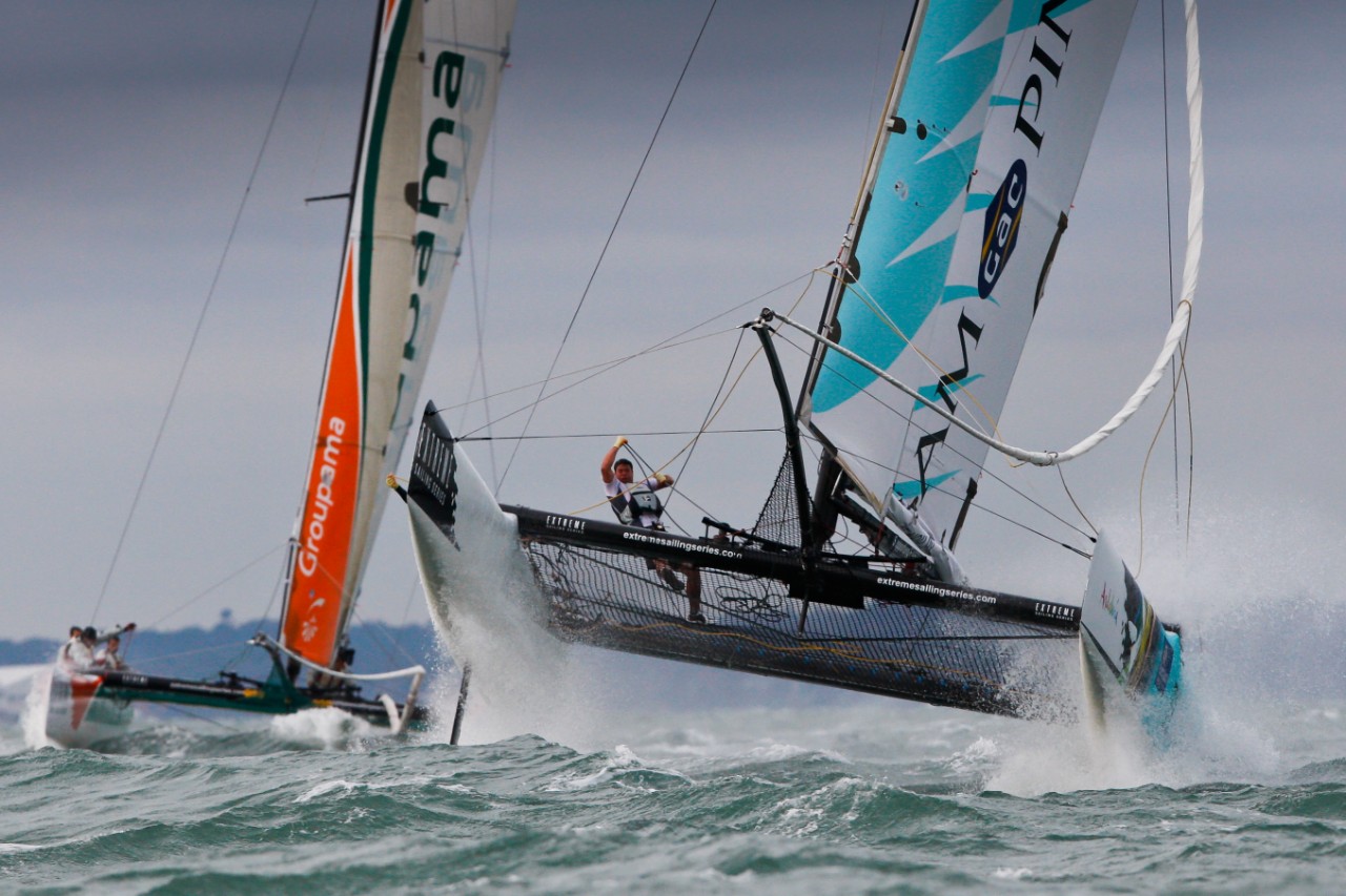 Nick Moloney navigating a sailboat in turbulent water.