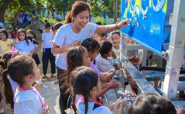 Children making us of and learning about clean water supplied by Planet Water Foundation