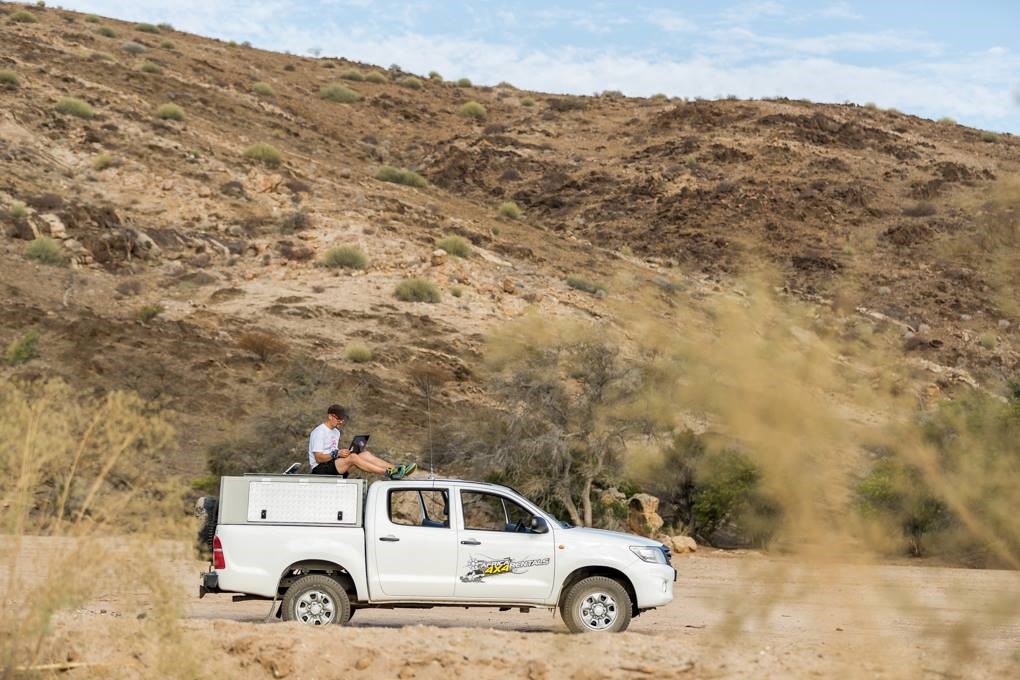 Man using BGAN on vehicle roof