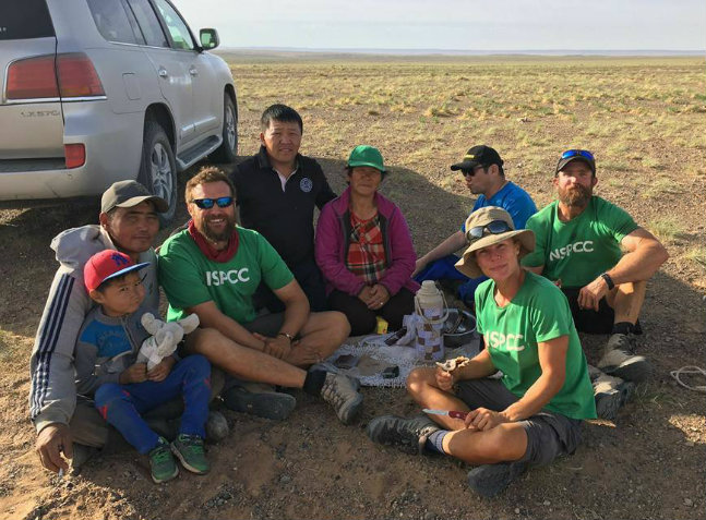 Team Essence being treated to a Mongolian barbeque by local residents who came  to see their land crossing