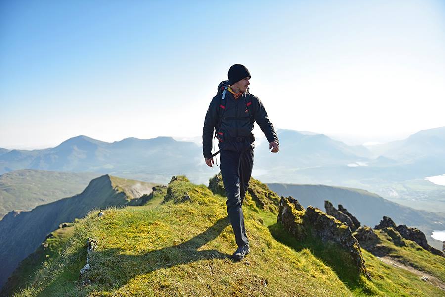 Ash Dykes walking across a hill range