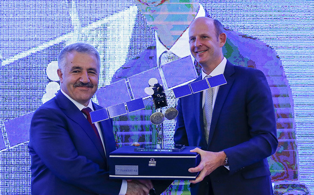 Turksat Transport, Maritime and Communication Minister Ahmet Arslan presenting a model satellite as a gift to Inmarsat CEO Rupert Pearce