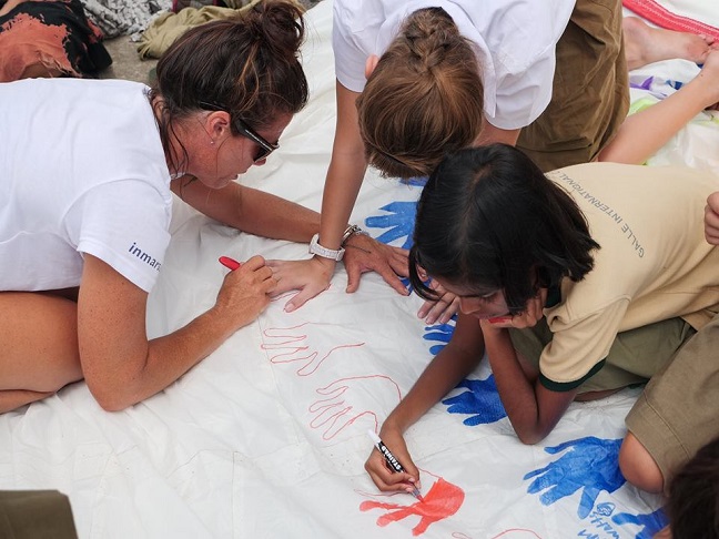 Girls leaving their handprints on a sheet onboard The Maiden Factor