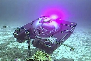 An image taken from video issued by Nekton shows a submersible from the vessel the Ocean Zephyr during a descent into the Indian Ocean off Alphonse Atoll near the Seychelles, Tuesday March 12, 2019. Members of the British-led Nekton research team boarded two submersible vessels and descended into the waters off the Seychelles on Tuesday, marking a defining moment in their mission to document changes to the Indian Ocean. The submersibles will be battling strong undersea currents and potentially challenging weather conditions as they survey the side of an undersea mountain off Alphonse Atoll. (Nekton via AP)