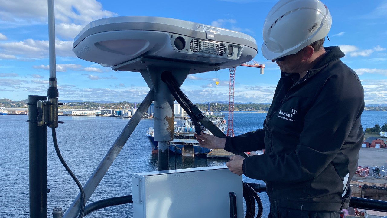 Technician working with a NexusWave terminal onboard a vessel