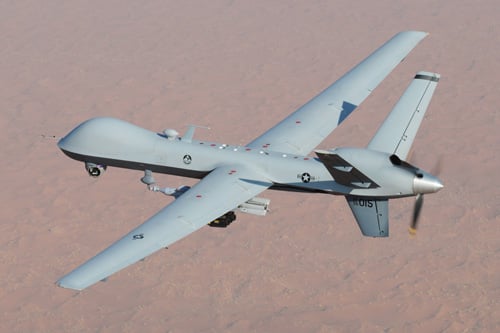 A grey US military MQ-9_Reaper UAV flying