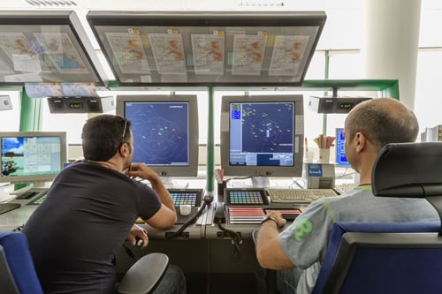 Air traffic controllers view air traffic data on radar screen