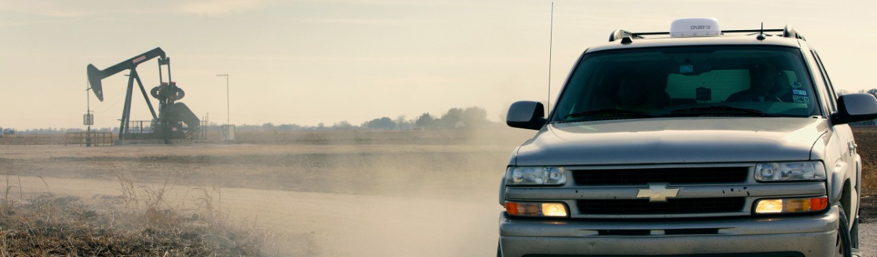 Four wheel drive vehicle near to oil wellhead