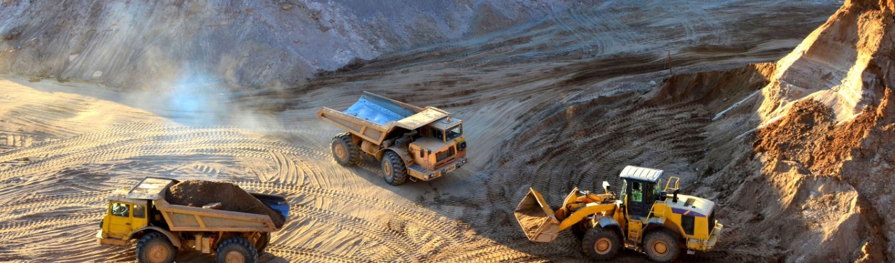 Heavy trucks working within an open mine