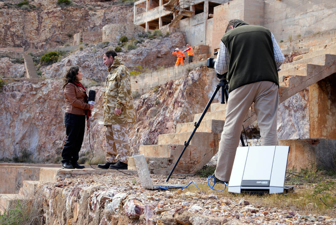 Film crew interviewing a rescue worker