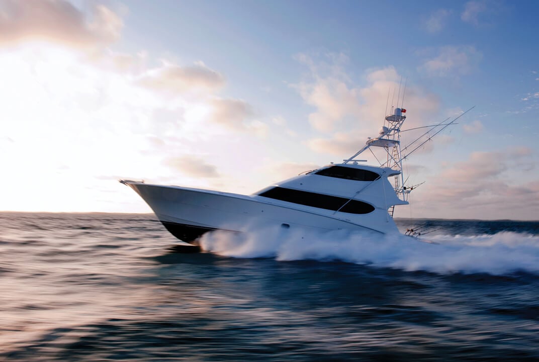 Modern powered yacht at speed at sea